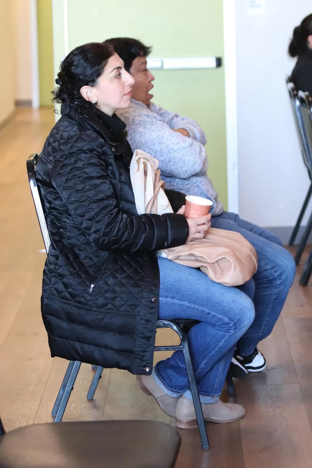 Una mujer ora de rodillas apoyada en la silla del salón