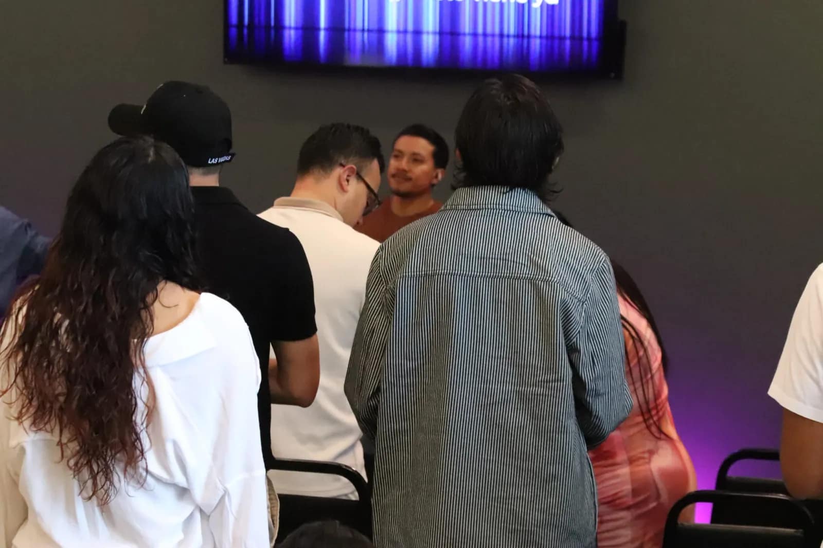 El grupo ora de pie formando un círculo al final del servicio